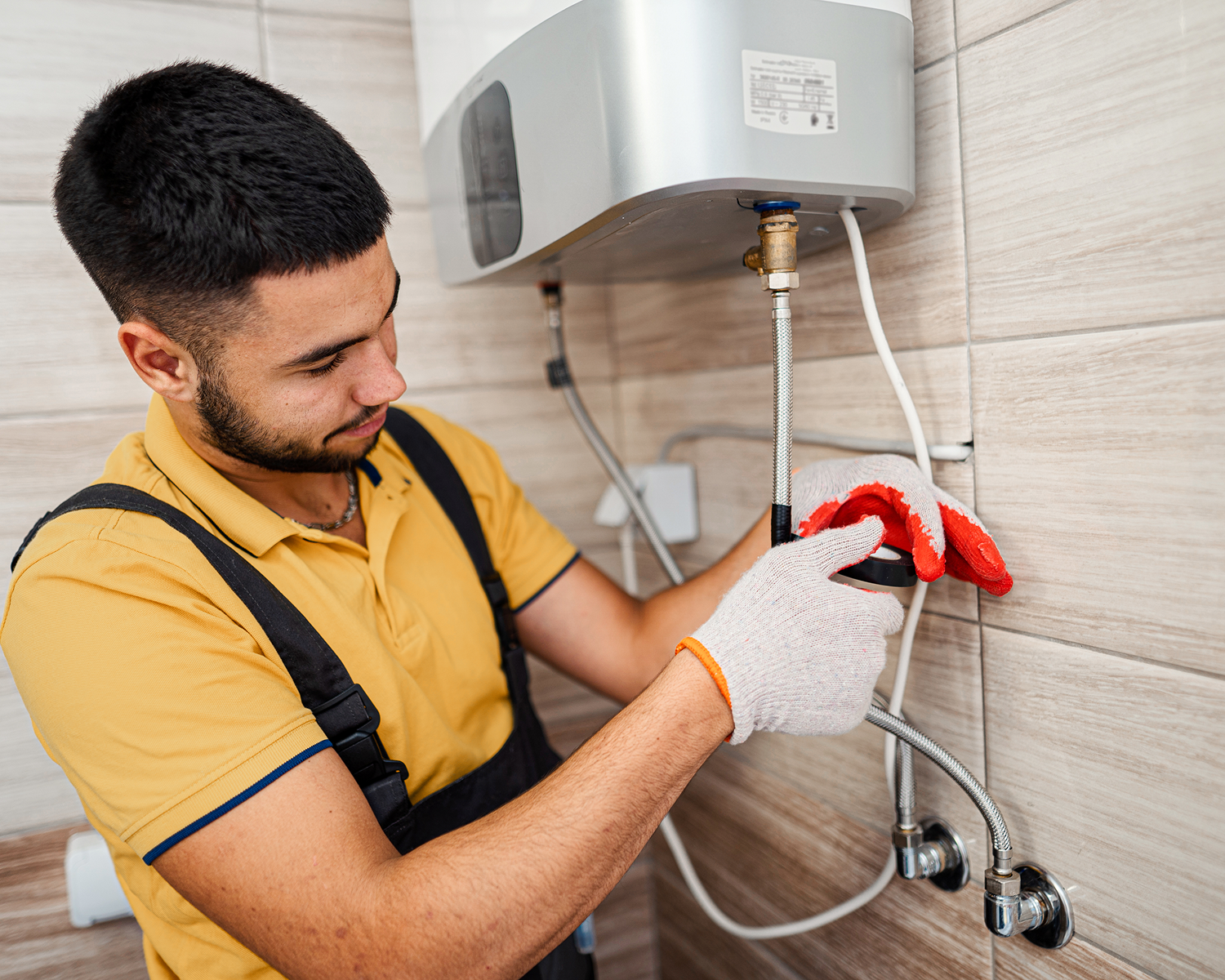 Man installing a water heater in bathroom.
