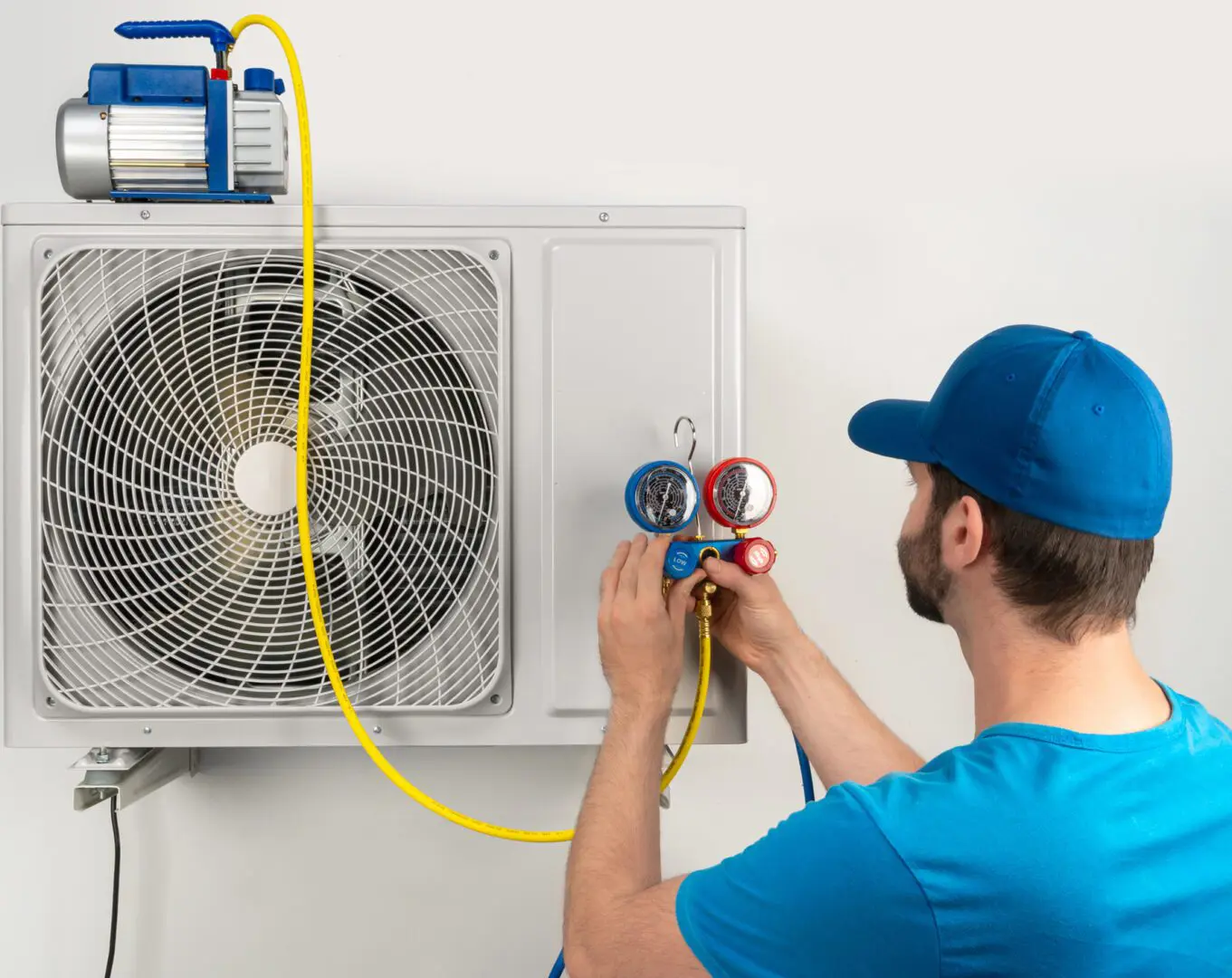 Technician servicing an air conditioning unit.