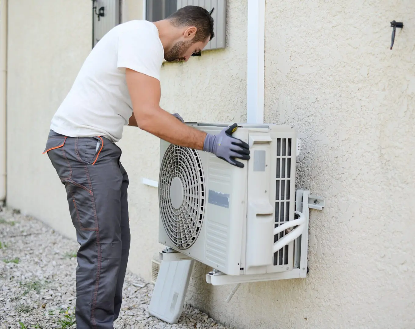 Technician installing an outdoor air conditioning unit.