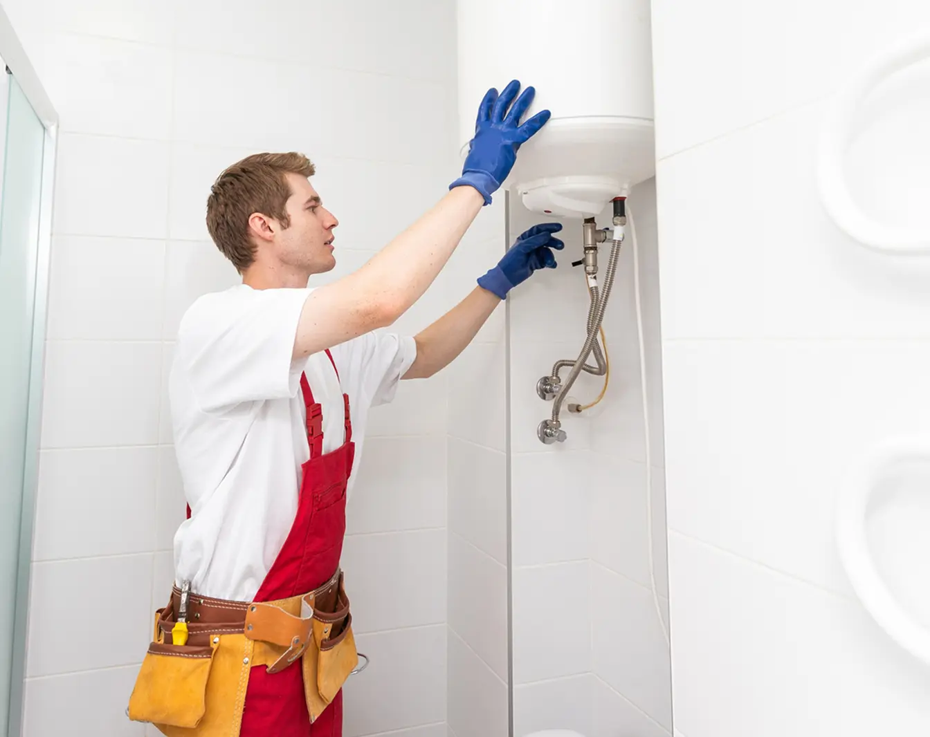 Plumber installing a hot water heater.