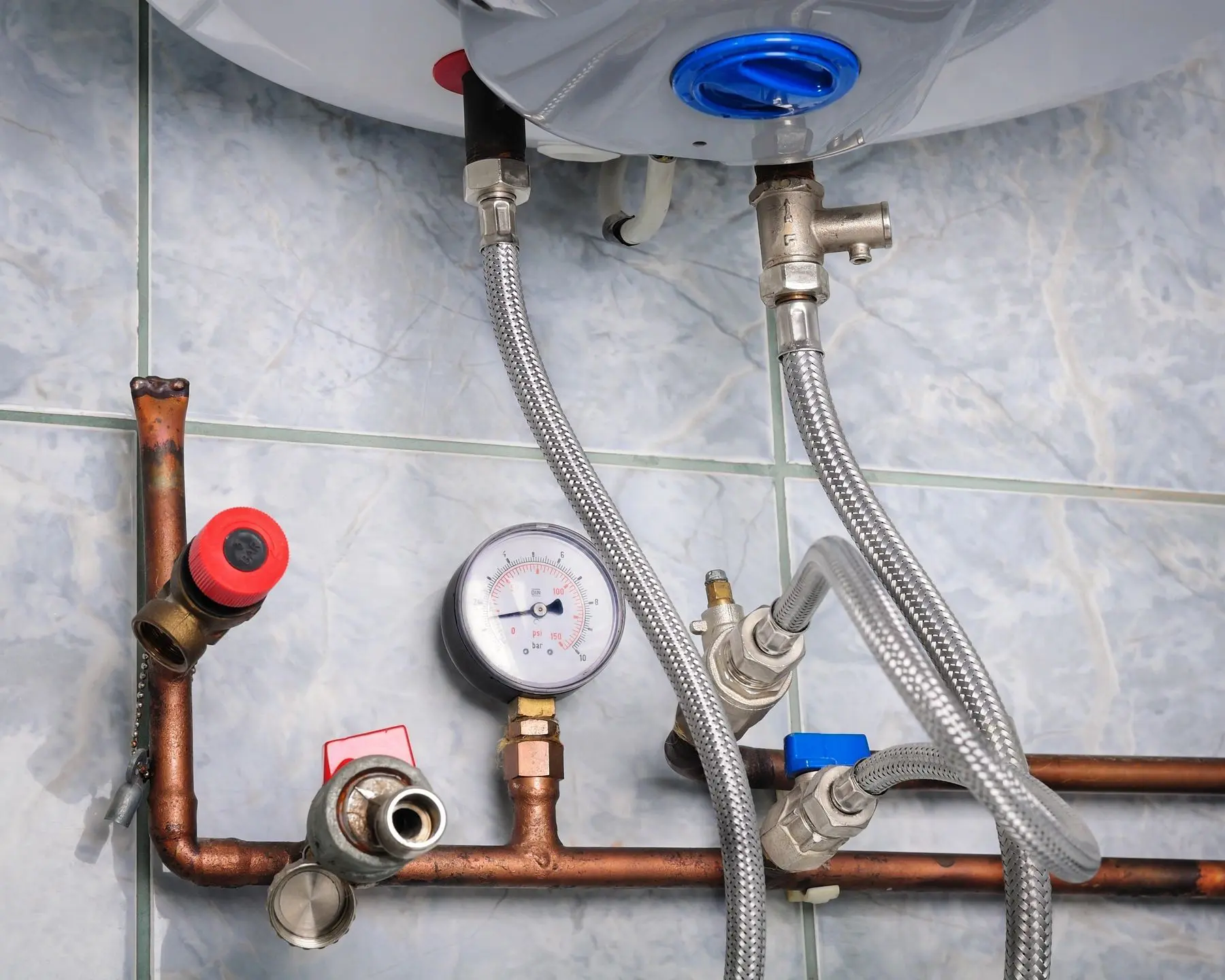 Water heater plumbing with pressure gauge