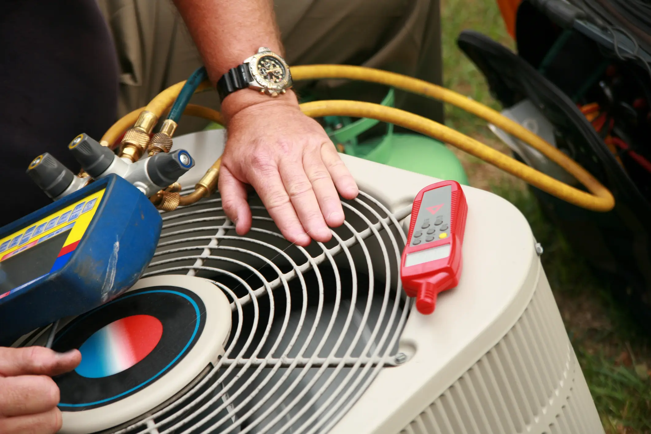 Technician servicing outdoor air conditioning unit