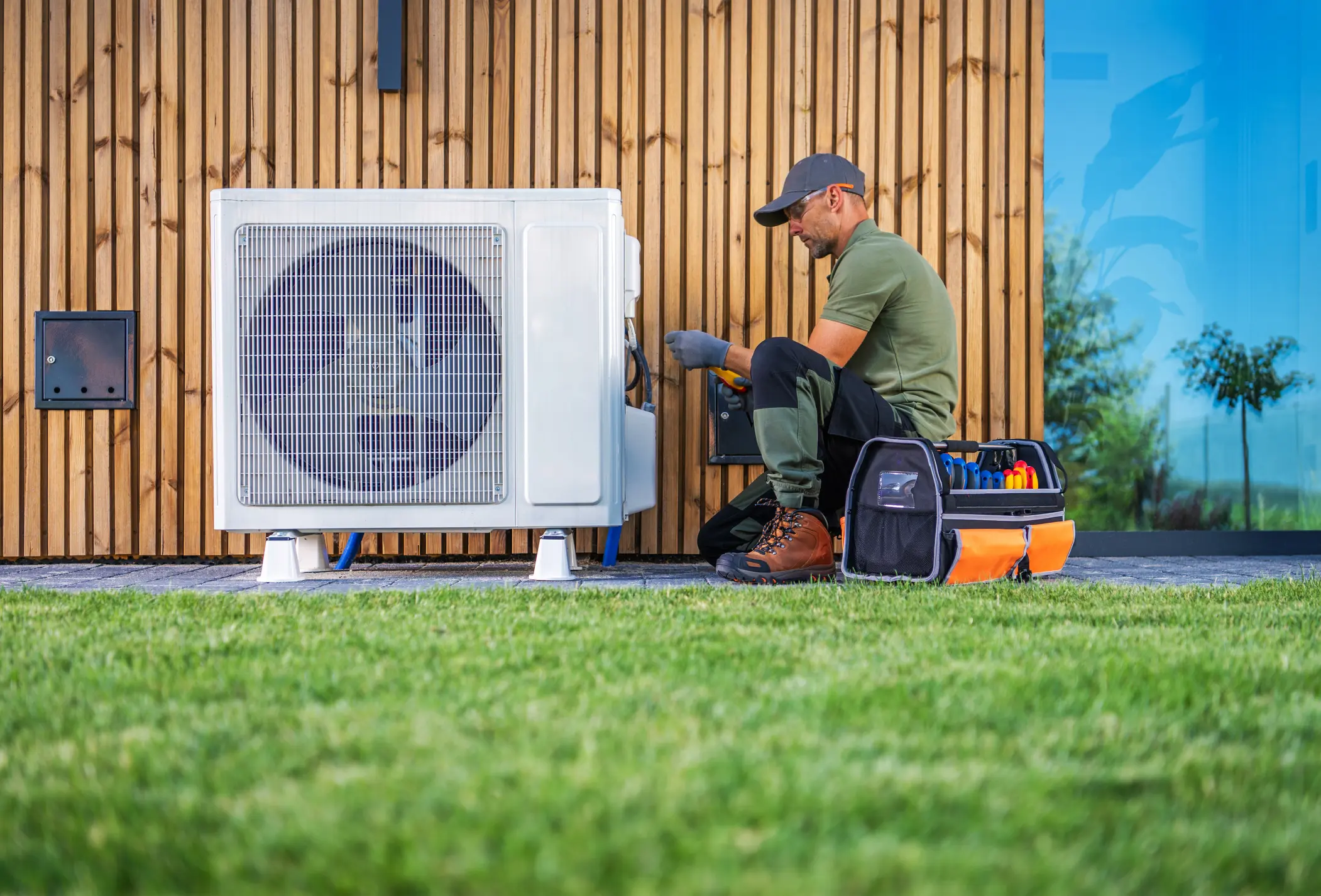 Technician repairing outdoor air conditioning unit