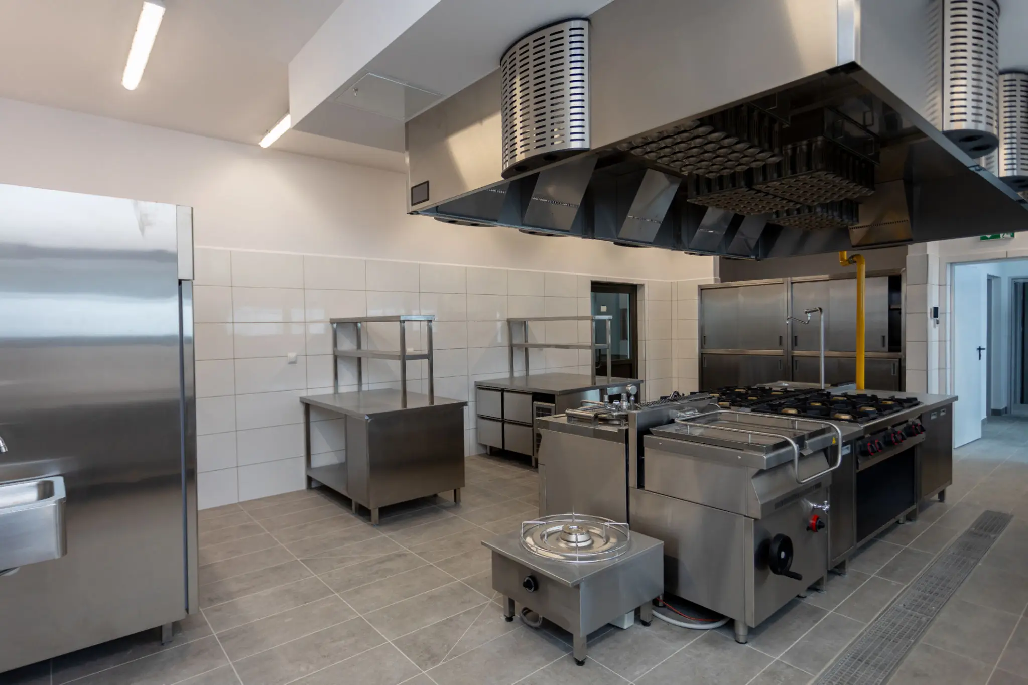 Empty commercial kitchen with stainless steel appliances