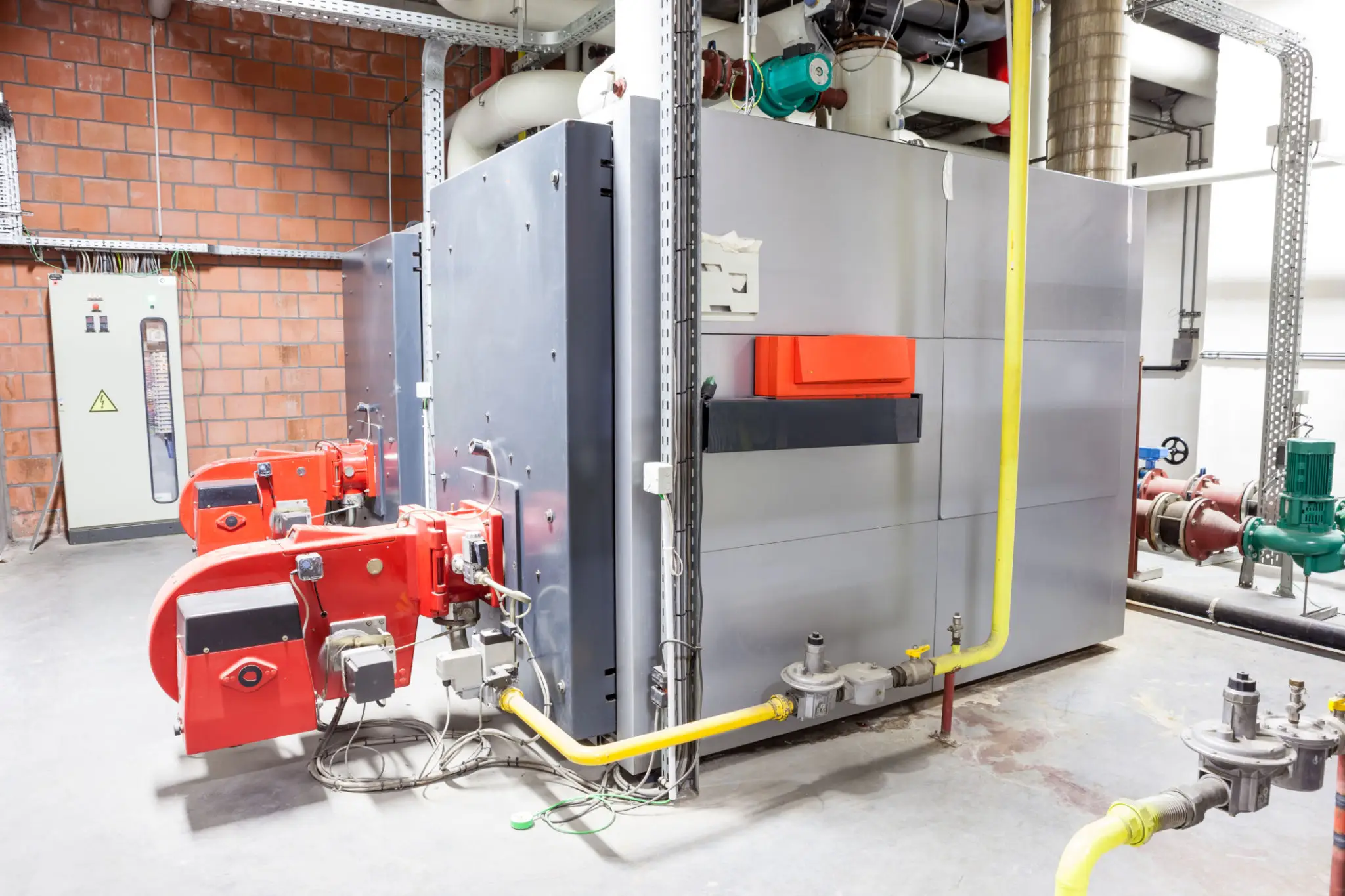 Industrial boiler with red burners and pipes