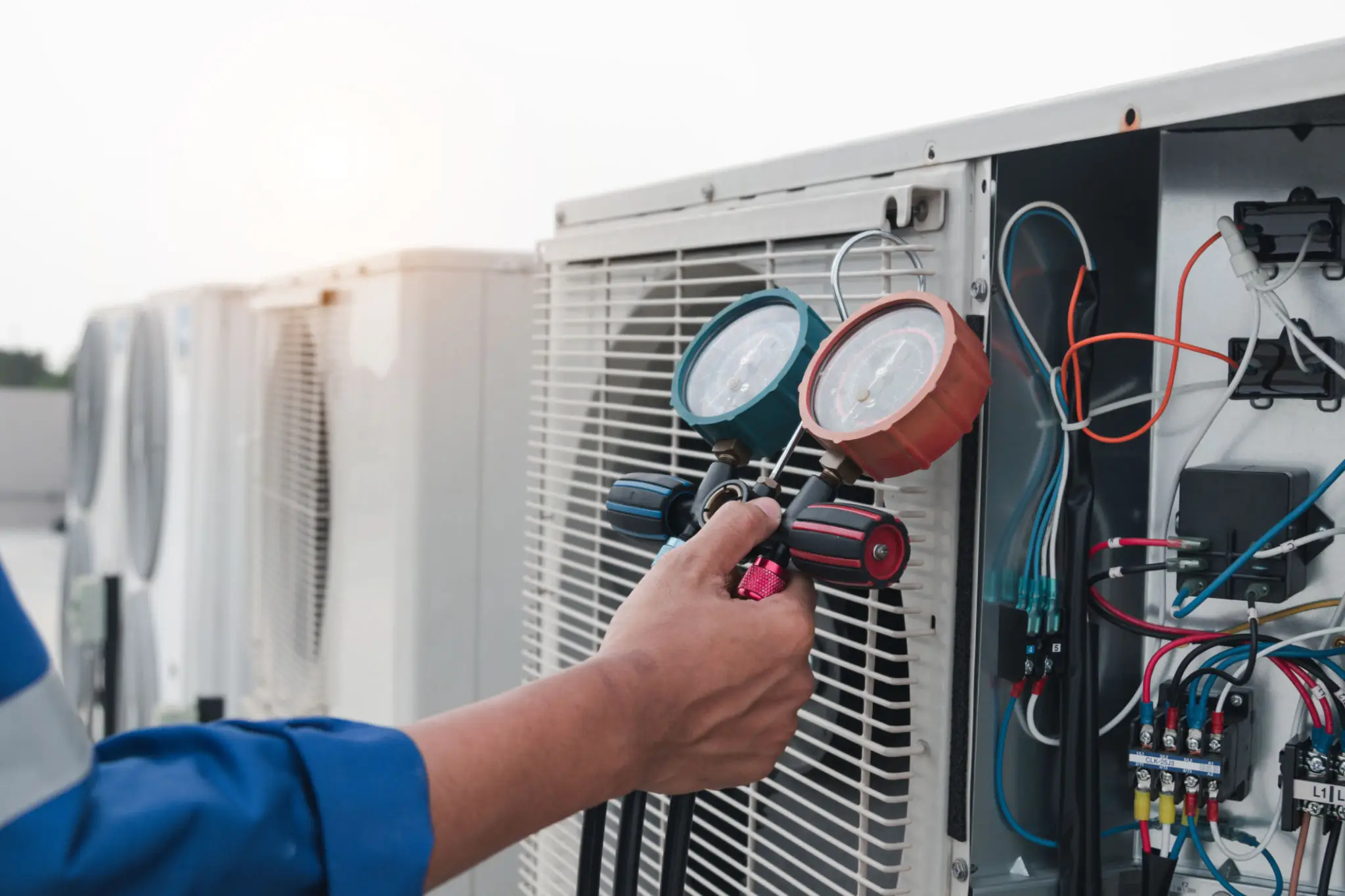 HVAC manifold gauges on outdoor AC unit
