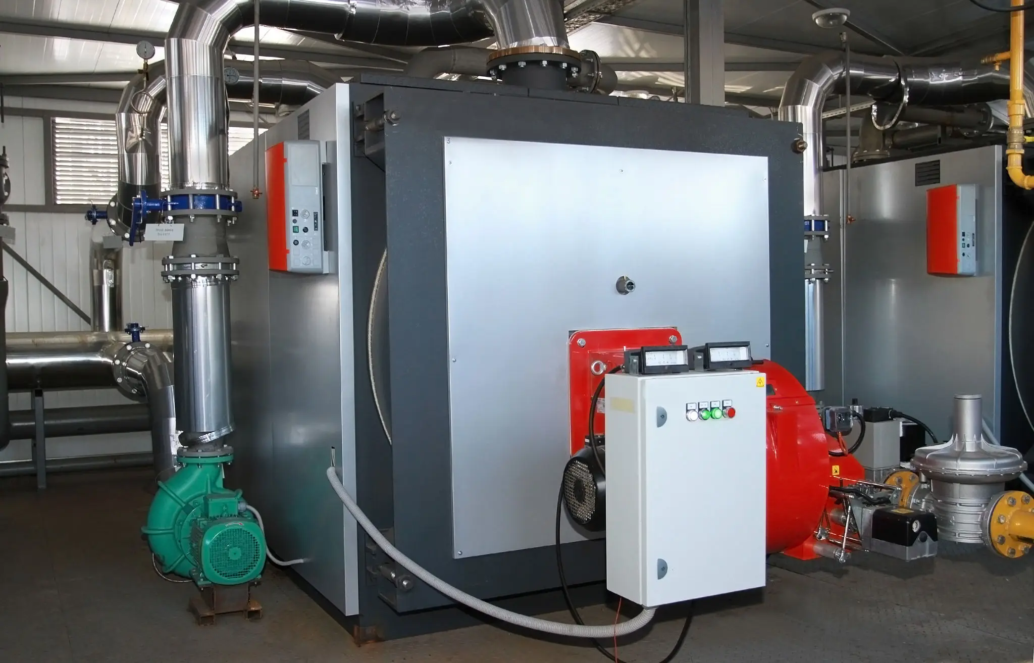 industrial boiler with control panel and piping