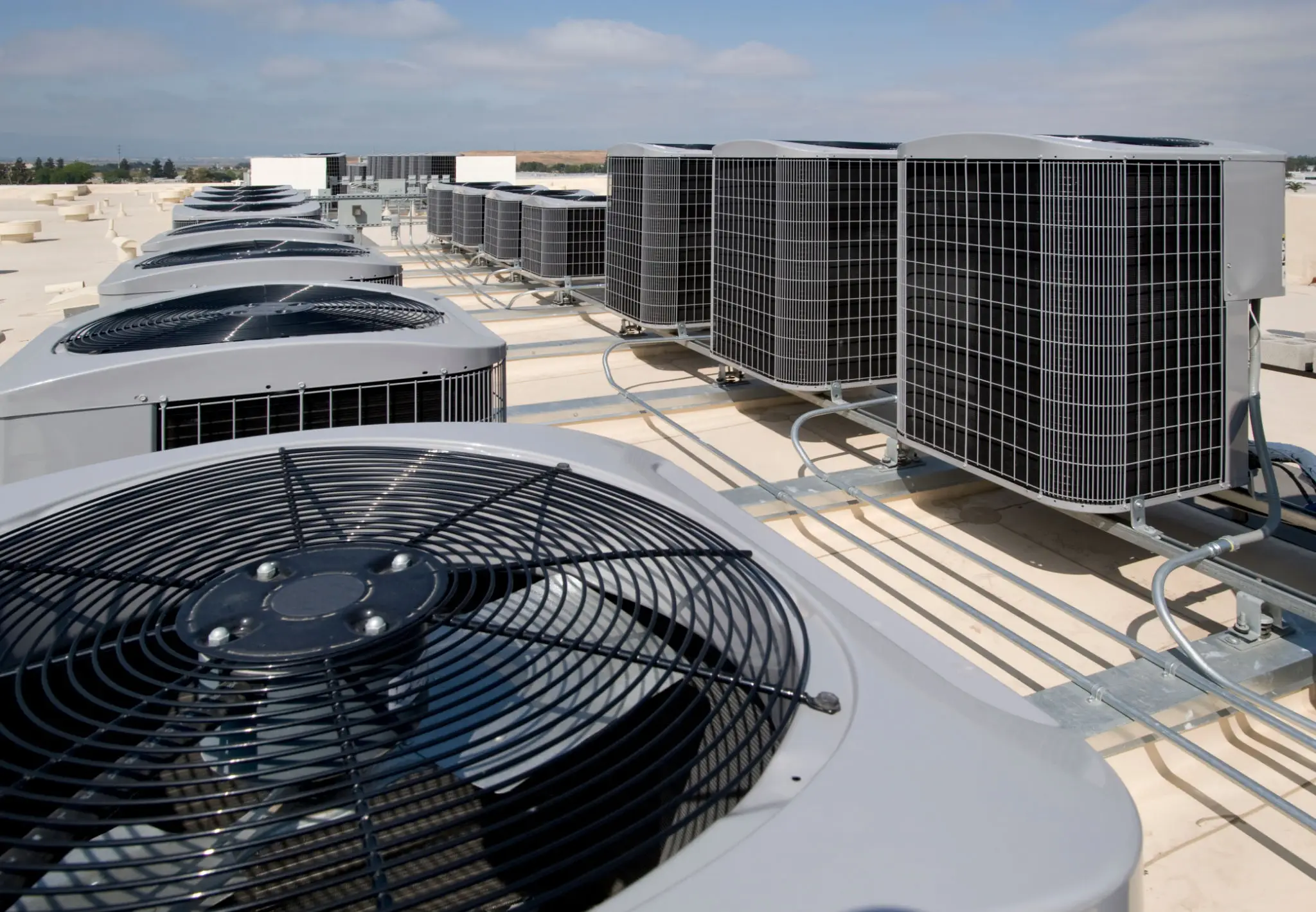 Row of rooftop commercial air conditioning units