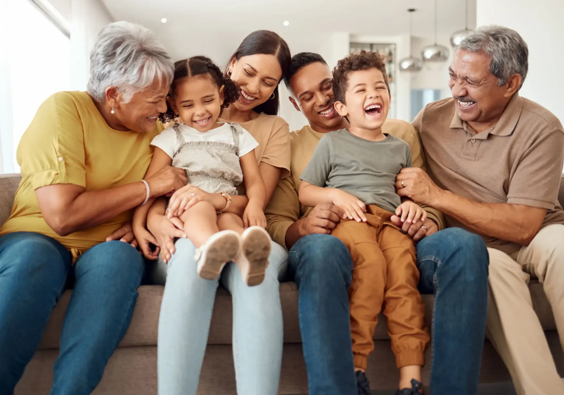 Multigenerational family laughing together on sofa